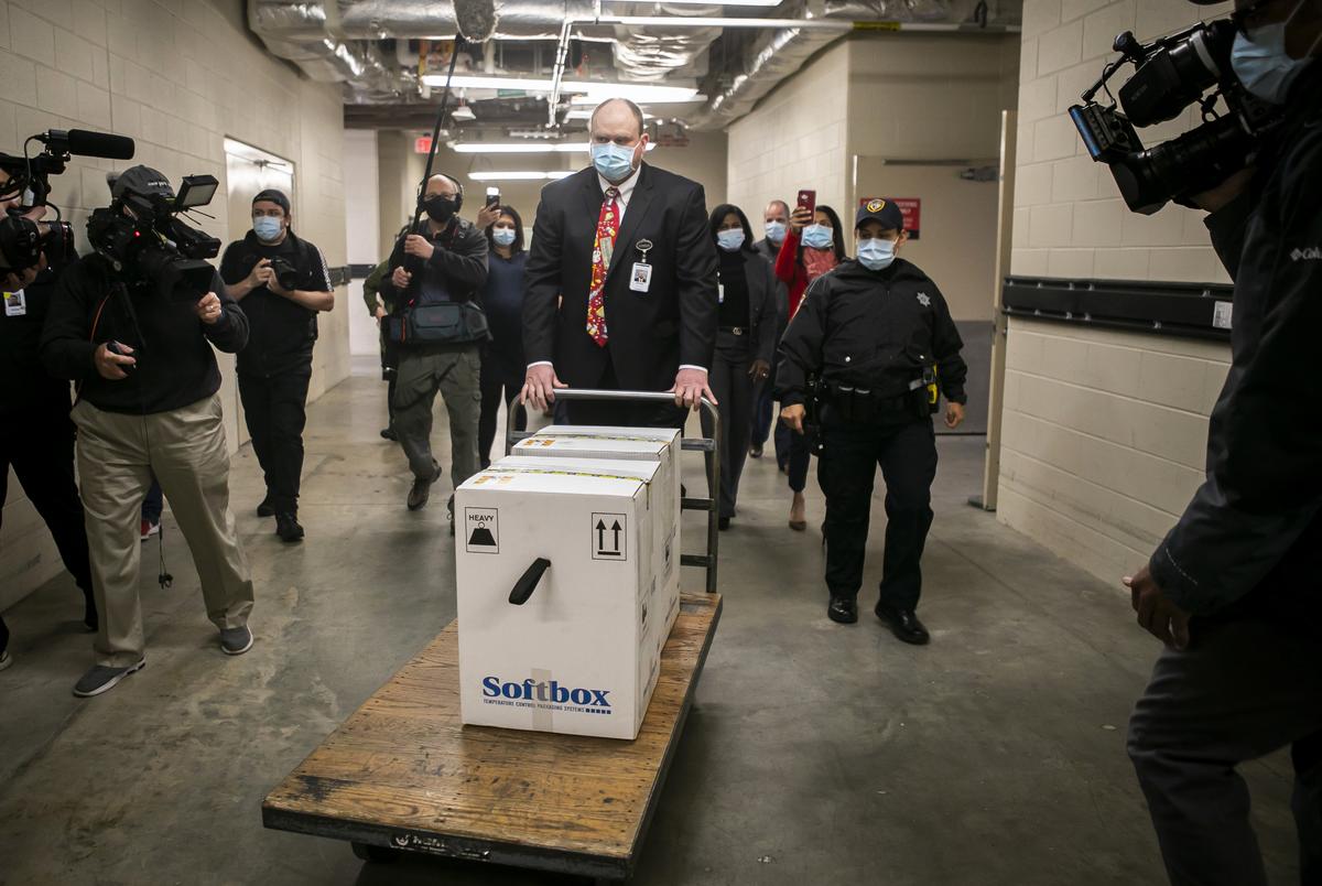 Sidney Phillips, administrative director of Pharmacy at Memorial Hermann Hospital, receives and transports the first Pfizer COVID-19 vaccines at Memorial Hermann Hospital in the Medical Center in Houston on Dec. 15, 2020.