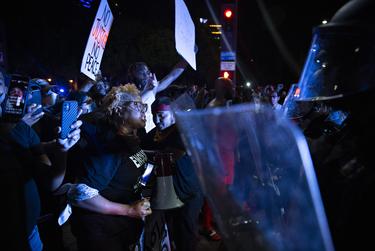 Protesters confront a line of Dallas police officers during the march in Dallas.