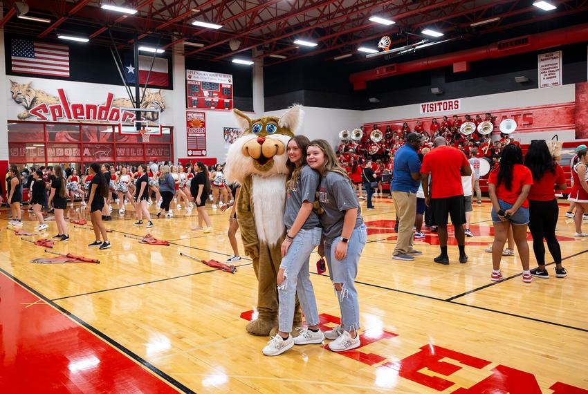 A mascot poses with students during the "Meet the Wildcats" community event at Splendora High School on Friday, Aug. 16, 2024, in Splendora.