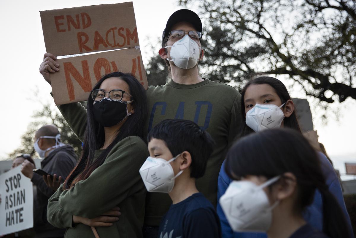 Susan Mire, her husband Shawn Mire, and their children (top to bottom) Evelyn, 10, Anthony, 8, and Gracie, 6, came the Grassy Knoll in Dallas to stand in solidarity with the Asian community and denounce racism and attacks on Asian Americans. 