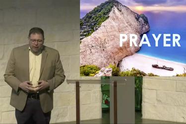 Preaching Minister David Duncan says prayer during a livestreamed service in Houston. 
