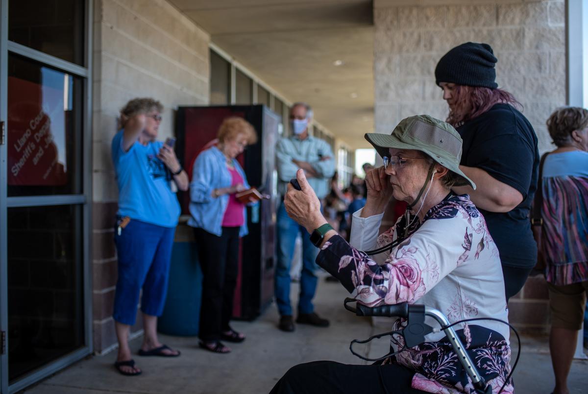 Residents gather outside the Llano County Sheriffs office on Thursday, April 13, 2023. The county ruled that the library will remain open after a vote on whether or not to close it due to disagreements over book banning. (Sergio Flores for the Texas Tribune)