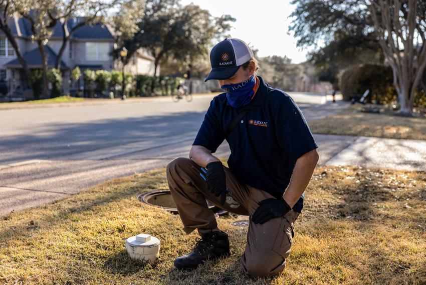 Zachary Shockency, a technician with Radiant Plumbing, turns off a City of Austin water valve at a home in West Austin on Fe…