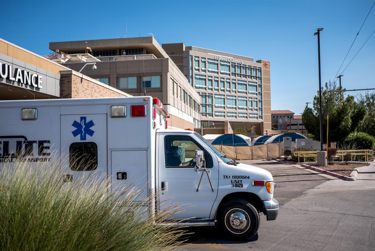 An ambulance drives past tents set up outside of the University Medical Center and El Paso Children's Hospital in El Paso on Oct. 23, 2020.