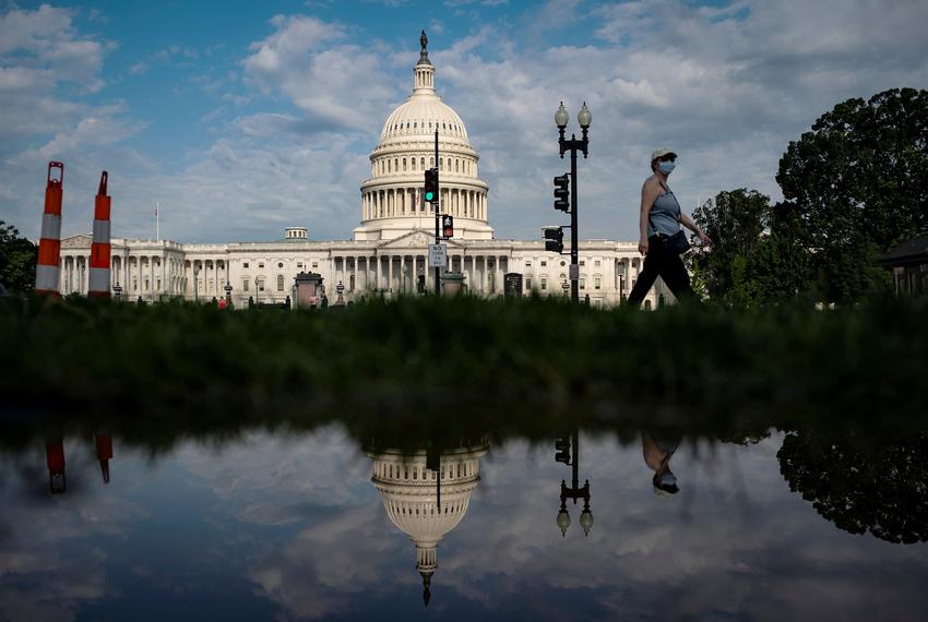 A woman walks past the U.S. Capitol in Washington, D.C.