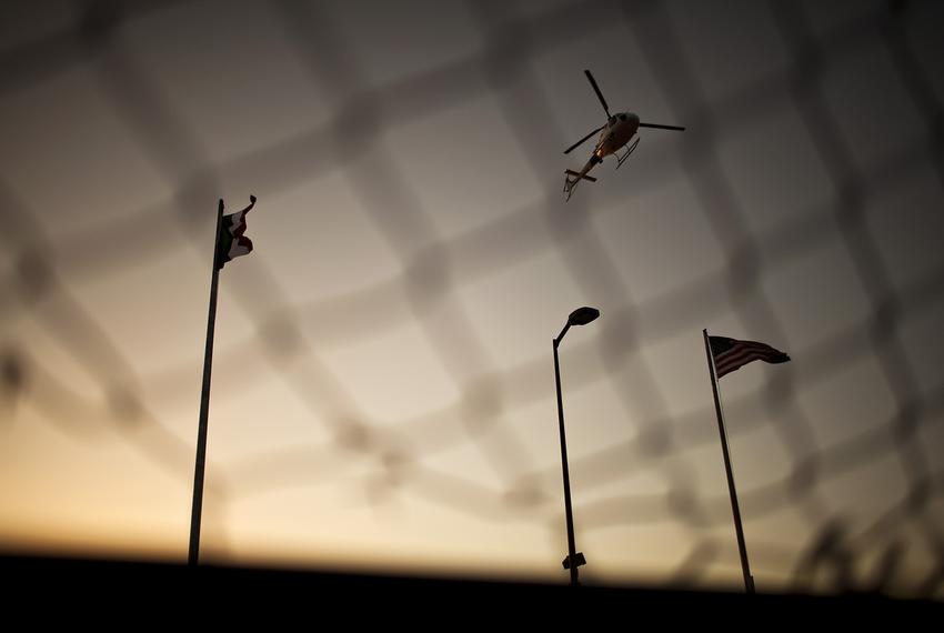 A U.S. Border Patrol helicopter patrols over the Paso del Norte International Bridge between El Paso, Texas and Ciudad Juárez, Mexico on Tuesday March 27, 2012.