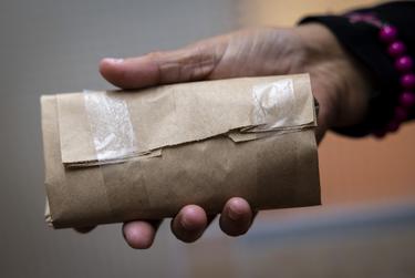 Valerie Polk shows a nondescript package containing 12 free condoms available for anyone at the clinic for Jasper-Newton County Health District in Jasper, TX, on Monday, Dec. 19, 2022.