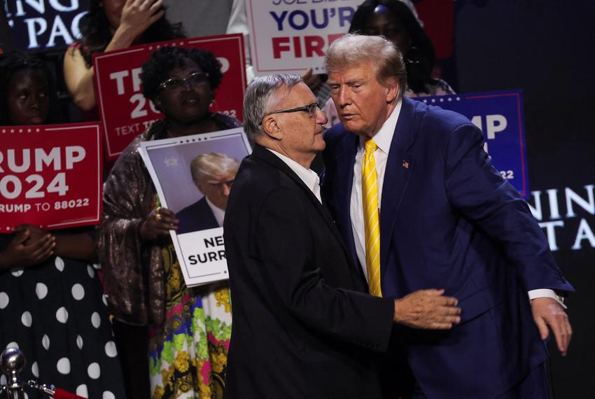 Then-Republican presidential candidate and former President Donald Trump embraces former Sheriff Joe Arpaio during a Turning Point USA event at the Dream City Church in Phoenix, Arizona on June 6, 2024.