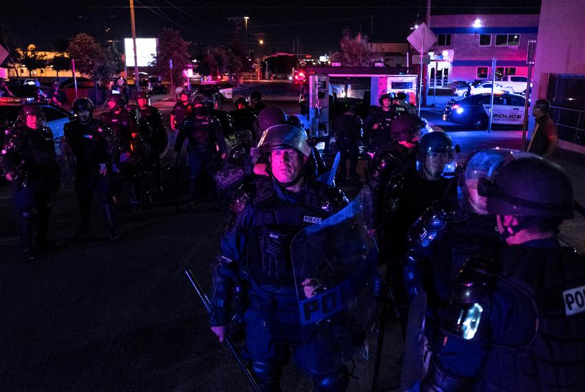 Law enforcement personnel stand guard in front of the El Paso Police Department headquarters building as protesters gathered nearby during a protest over the death of George Floyd on May 31, 2020.