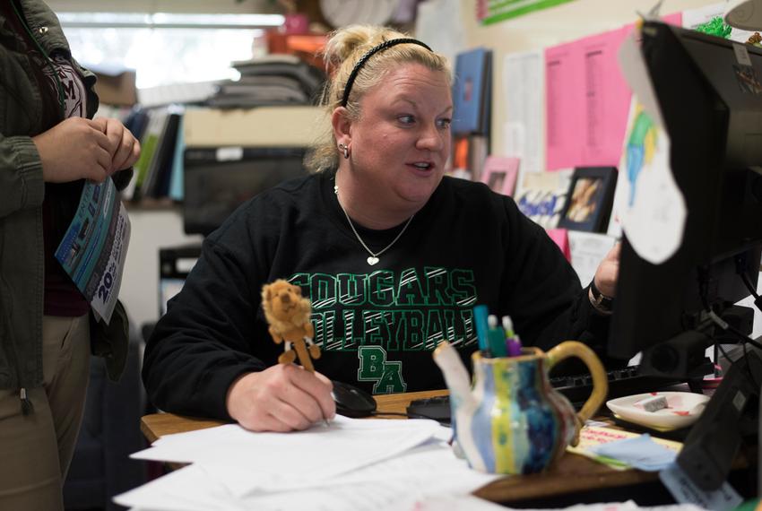 Coach Krystal Morrow works at her desk at Bryan Adams High School in Dallas, Texas.