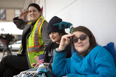 Hayley Enoch, Zoey Johnson, Layla Johnson practice their presidential salutes. The trio arrived early in the morning to the train tracks near Washington Ave. in Navasota. 