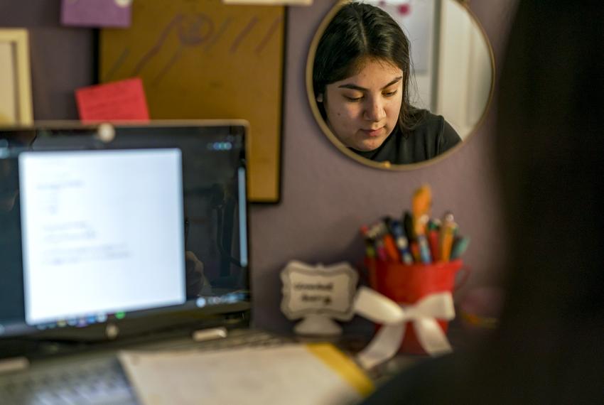 Before the start of the school day, Isabel Suarez works on homework from her home in Pflugerville. Dec. 9, 2020.