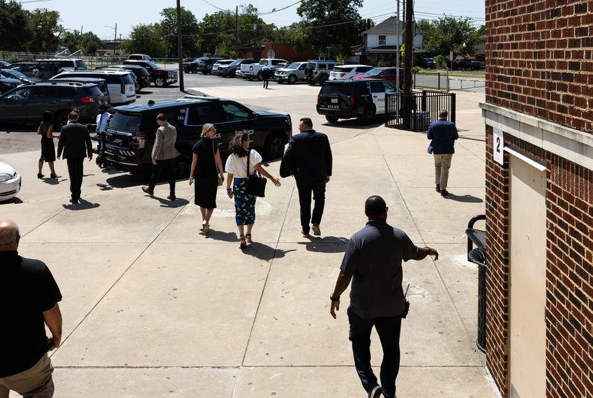 Local and state education officials walk to their cars outside Fort Worth ISD’s William James Middle School on Aug. 28, 2025.