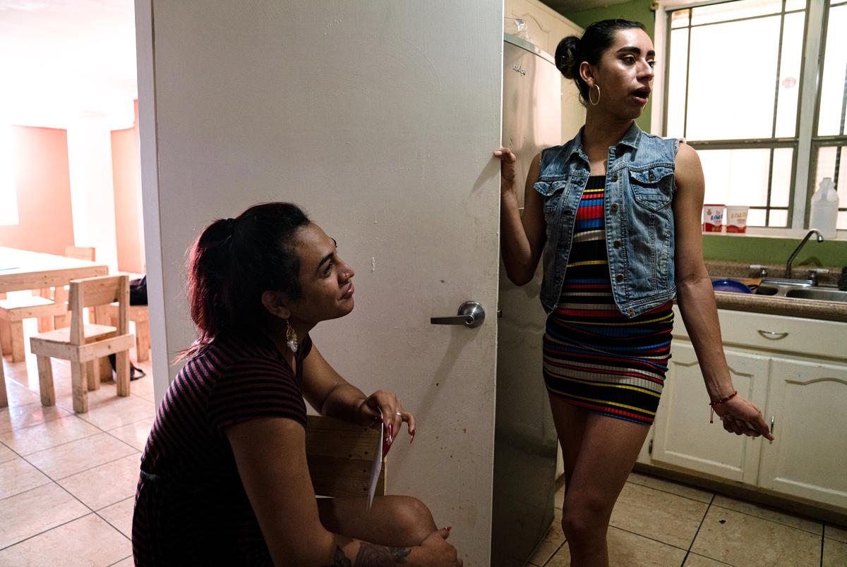 Valery Sanchez, 19, left, talks to her friend Natasha Mayorquin, 24, both asylum-seeking transgender women from Honduras, at Rainbow Bridge, a shelter where they live in Matamoros, Mexico on Feb. 26, 2021. Both of them lived at the migrant camp and because they feared for their lives, they moved to the shelter that is for LGBTQ asylum seekers where they can be safer.