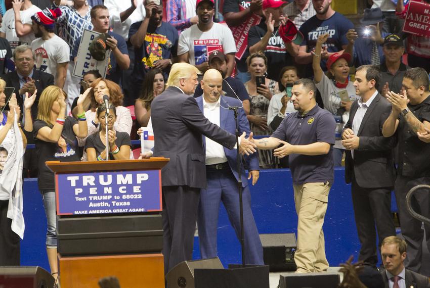 Republican Presidential nominee, Donald Trump greets a group of border patrol agents on stage during an August 23, 2016 rally. Trump announced the border patrol endorsement during the rally