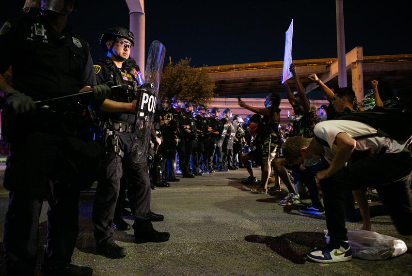 Police officers engage in a standoff with protesters Tuesday night in Houston, Texas.