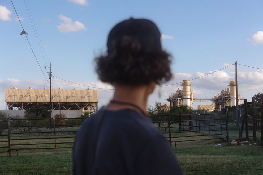 Cheryl Shadden looks towards the Marathon cryptocurrency facility and the Wolf Hollow II power plant while being interviewed on her land in Hood County on September 24, 2025.
