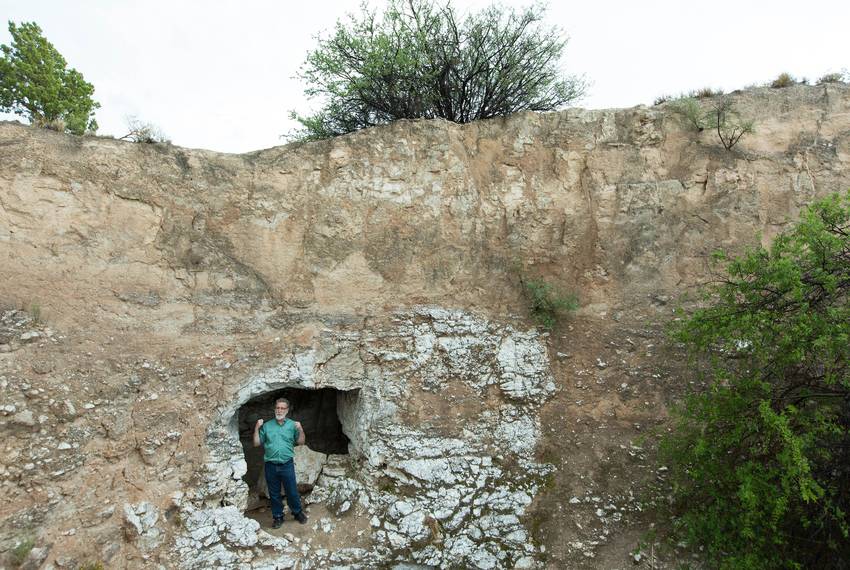 George Veni, executive director of the National Cave and Karst Research Institute, stands above a stream that flows out of Parks Ranch Cave near Carlsbad, N.M., on May 23, 2018. The cave is an example of karst, a porous limestone.