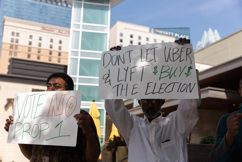 President of Taxi Drivers Association of Austin, Dave Passmore, right, and board member, Nega Taddesse, left, spoke to the media about their concerns with Uber and Lyft on March 15, 2016. Alongside Passmore and Taddesse, a group of drivers gathered outside a major South by Southwest event to protest Uber’s attempt to bully the City of Austin into adopting its version of a ride-sharing ordinance.