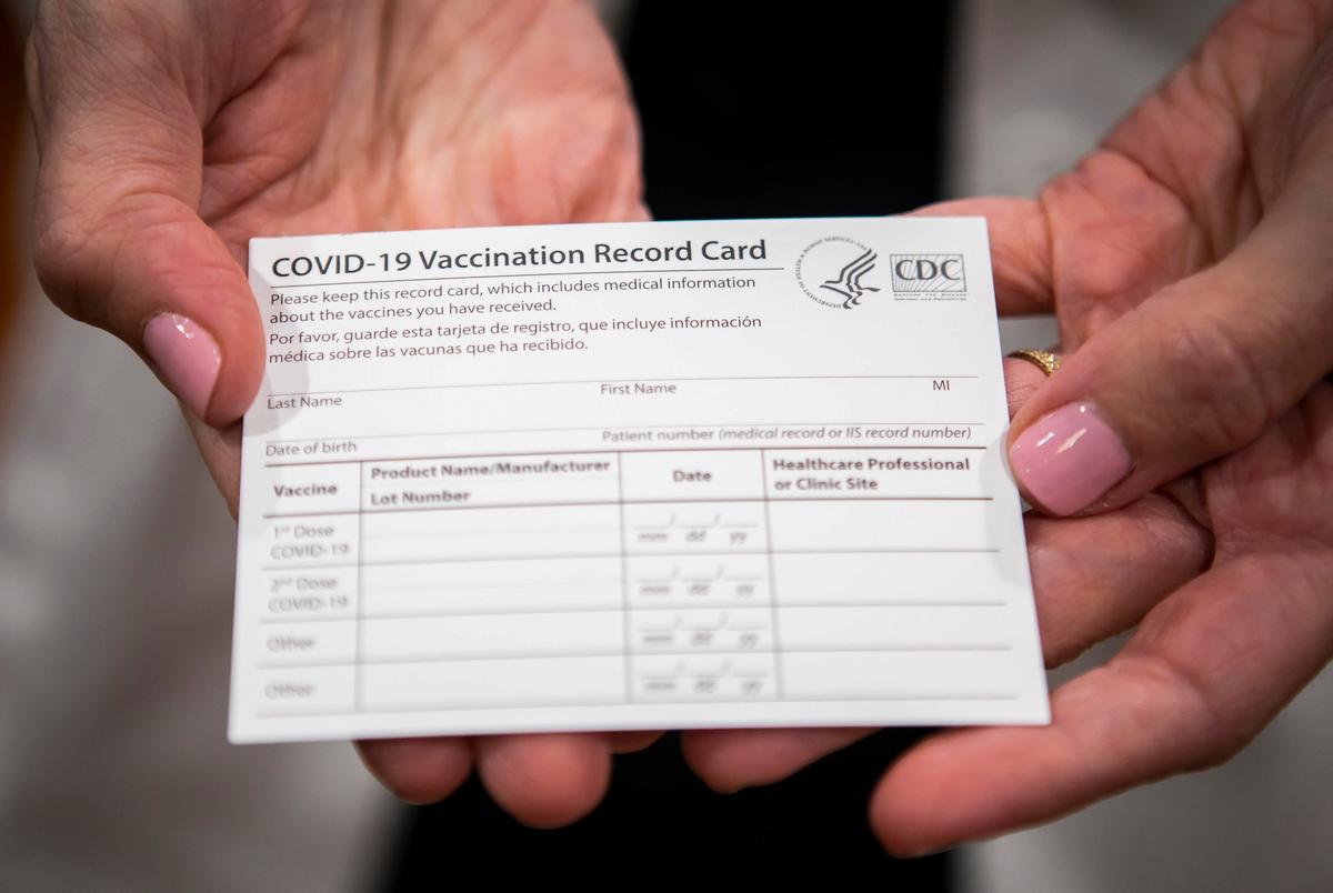 Dr. Annamaria Macaluso Davidson holds a COVID-19 vaccine registration card at Memorial Hermann Hospital in the Medical Center in Houston on Dec. 15, 2020.