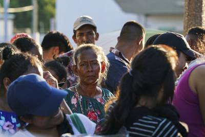 Asylum seekers wait in line to get a meal provided by Team Brownsville near the Gateway International Bridge in Matamoros, Mexico on Sunday, Oct. 13, 2019. Most of the people have been sent back under the Migrant Protection Protocols, MPP, also known as “Remain in Mexico” program along with some Mexican nationals awaiting their turn to seek asylum in the U.S.
Verónica G. Cárdenas for The Texas Tribune