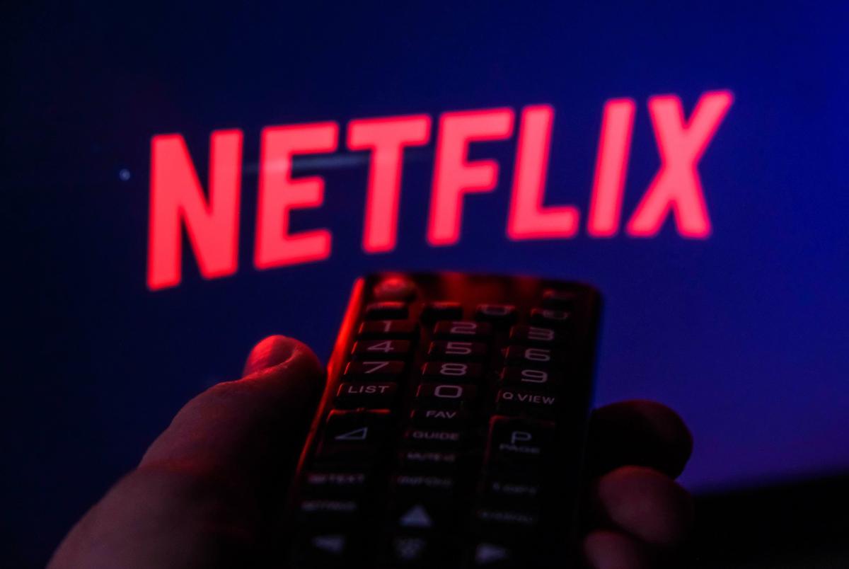 TV remote control is seen with Netflix logo displayed on a screen in this illustration photo taken in Krakow, Poland on February 6, 2022.