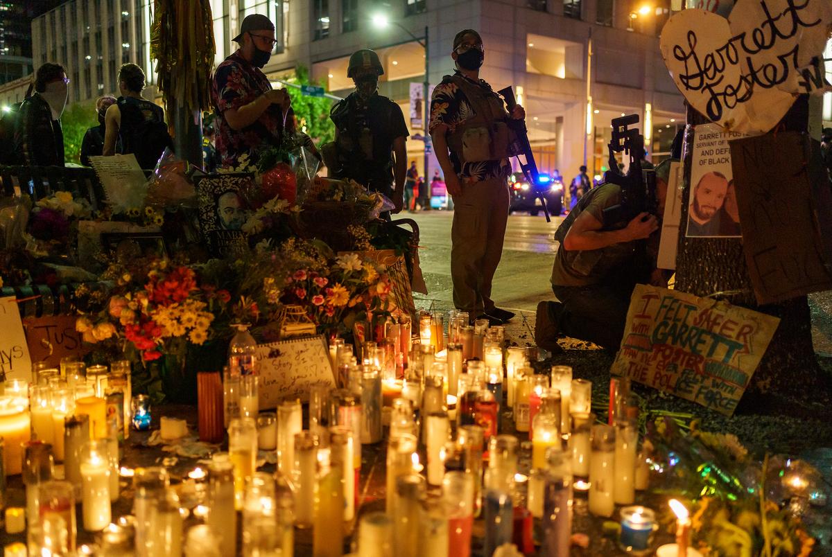 Armed Protestors guard the memorial to Garrett Foster, who was shot and killed during a protest against police brutality in Austin in July. 
