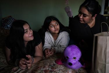 Adelyn Vigil, 13, left, a transgender girl, her cousin Aylette Reyes, 13, center, and her mother Adamalis Vigil, 34, pass their time at her grandma’s home in the Rio Grande Valley on Sunday, February 27, 2022. Verónica G. Cárdenas for The Texas Tribune