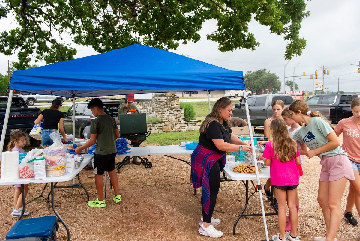 Volunteers help set up a food station at Cross Kingdom Church on Saturday, July 5, 2025, in Kerrville, Texas.
