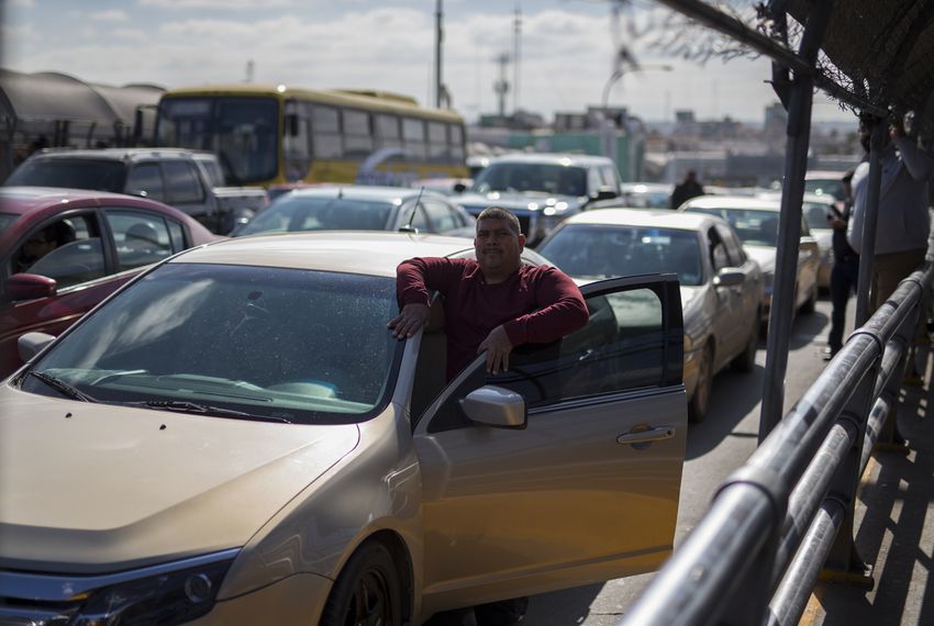 A man waits outside his car as Customs and Border Protection officials conduct "operational readiness exercises" at the Paso del Norte Port of Entry on Nov. 9, 2018, in El Paso, Texas.