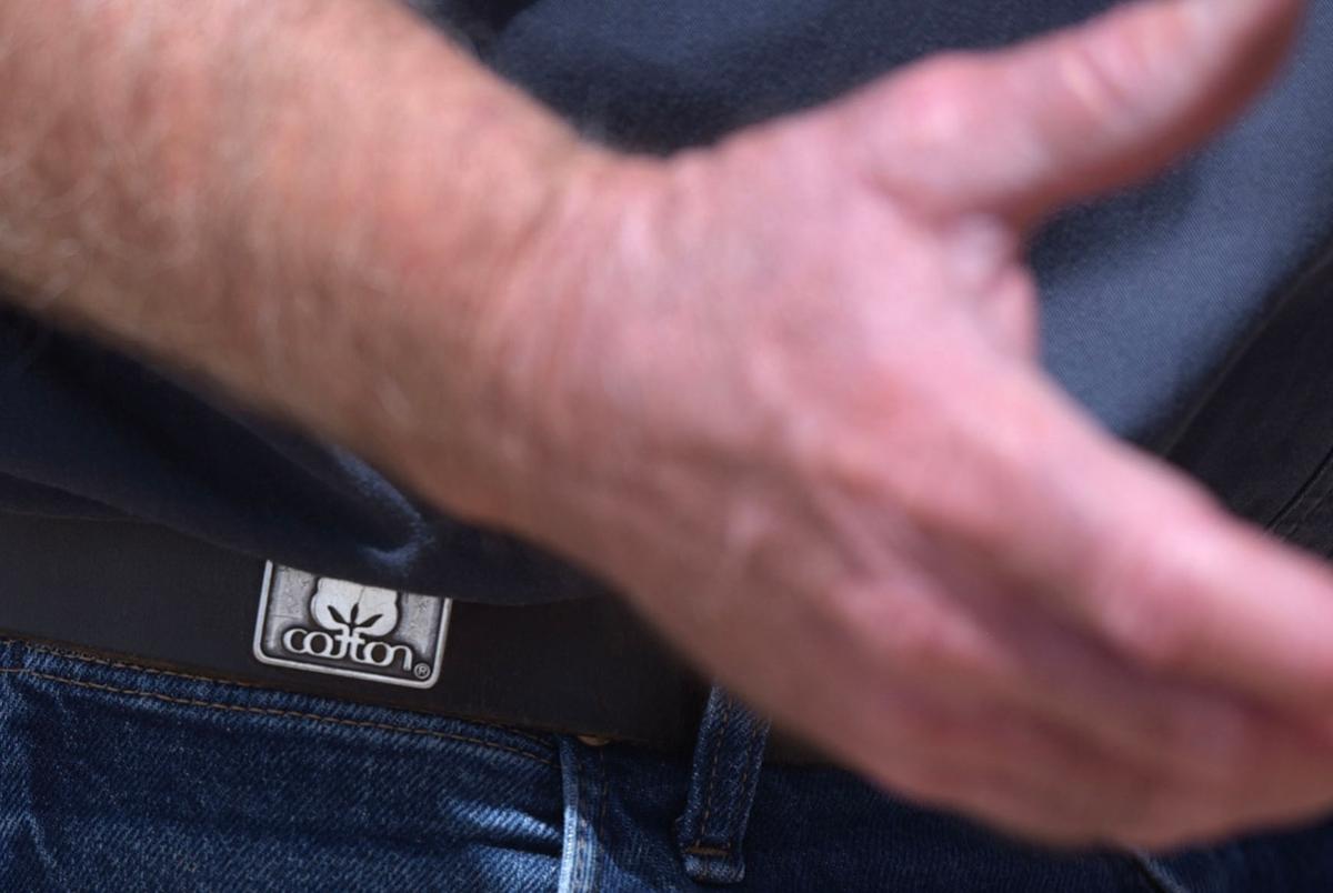 Walt Hagood wears a belt with a “cotton” logo on it. Hagood has been planting cotton since 1979.