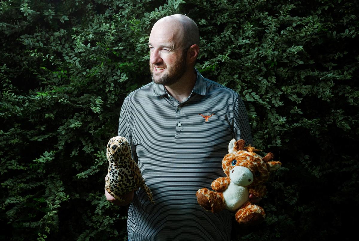 Danny McDonald, an attorney in Boerne, holds a stuffed giraffe and a stuffed seal he found while volunteering in search efforts in the aftermath of the Kerr County flood.
