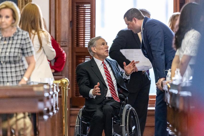 Gov. Abbott speaks with lawmakers on the house floor during the legislative session on the house floor on Sunday, May 23, 2021.