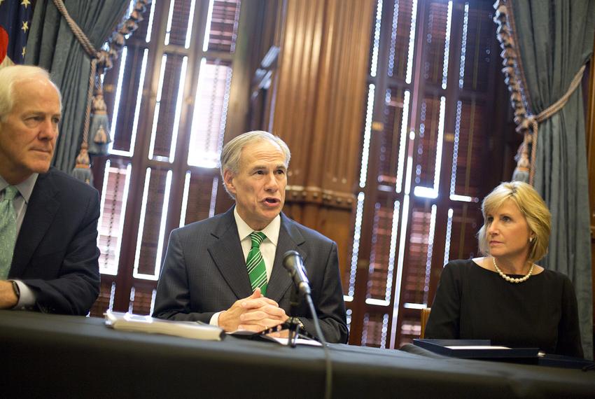 Gov. Greg Abbott speaks at a press conference on Harvey recovery efforts at the state Capitol on Nov. 17, 2017. Abbott is flanked by Sen. John Cornyn and Pam Patenaude, deputy secretary for the U.S. Department of Housing and Urban Development.