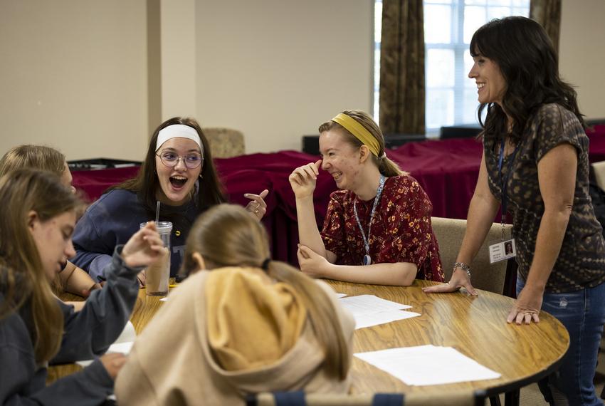 Teacher and parent Jamie Johnston, right, laughs with a group of secondary level students as she teaches a College & Career Readiness at REACH Homeschool Co-op in Clear Lake, TX. Johnston teaches while her three children attend their classes at the school.