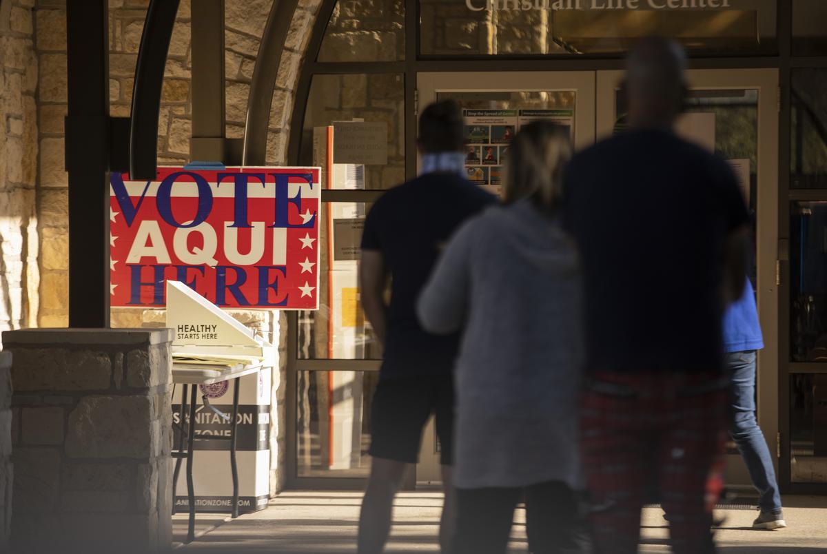 Voters wait in line at a polling site at Austin Oaks Church on Oct. 14, 2020.