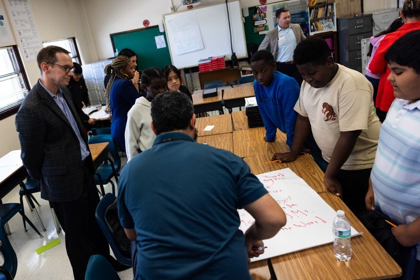 Texas Education Commissioner Mike Morath watches a group of seventh graders read a poem in Fort Worth ISD’s William James Middle School on Aug. 28, 2025.