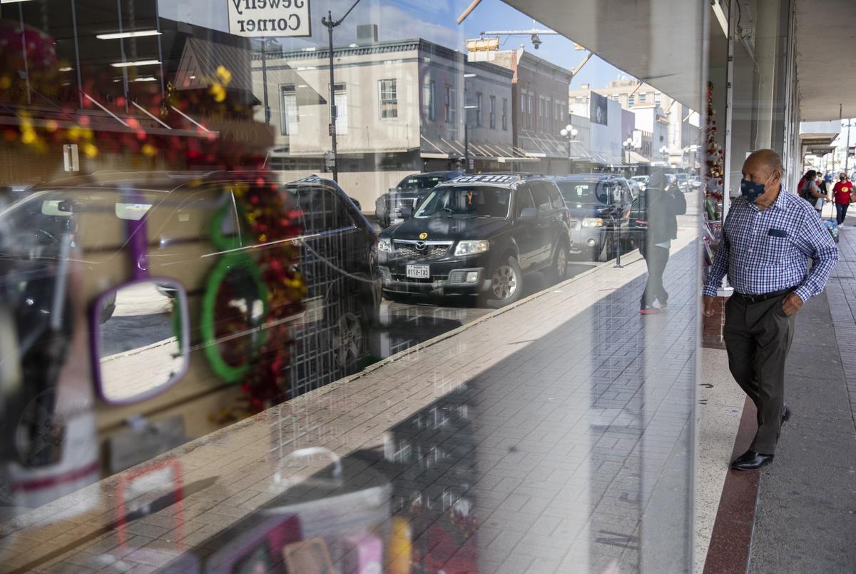 Pedestrians walk through downtown and enter shops and restaurants in Brownsville on Nov. 8, 2021. The U.S. Department of Homeland Security reopened its ports of entry to vaccinated travelers from Mexico after 19 months of closure.