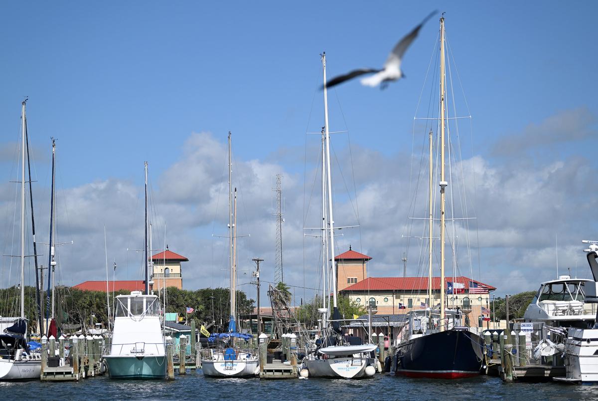 The Rockport City Hall Building (left) and the newly-built Aransas County Courthouse (right) can be seen over the boats docked in the Rockport Harbor.