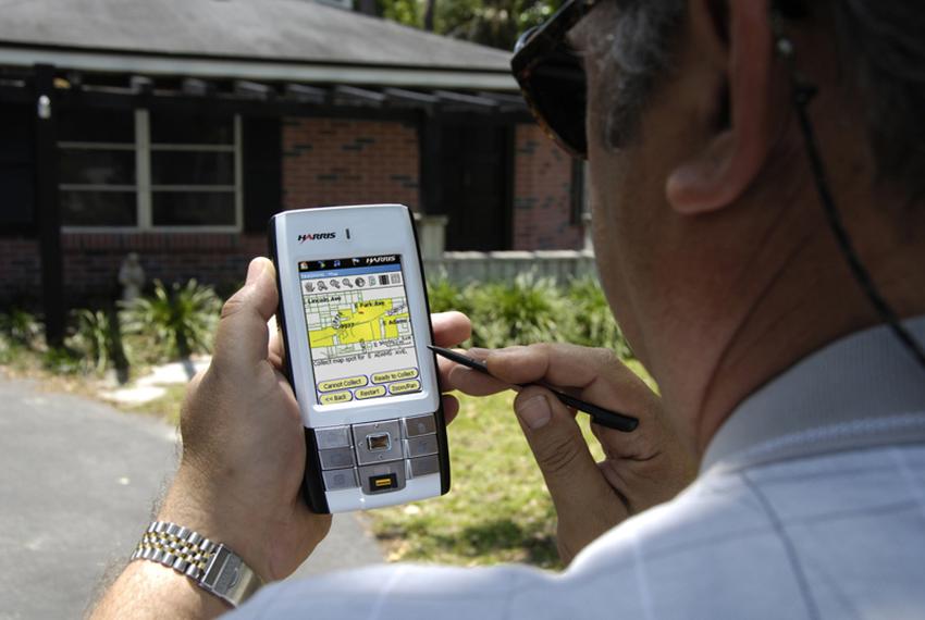 A U.S. Census Bureau worker confirms addresses with a hand-held device.