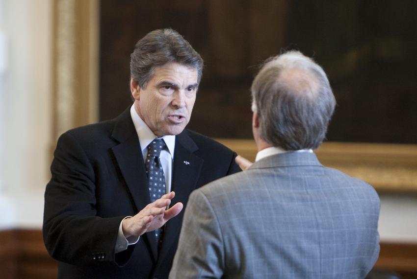 Gov. Rick Perry (l) gestures toward Sen. Kirk Watson, D-Austin, during his visit to the Senate floor on May 5, 2011.