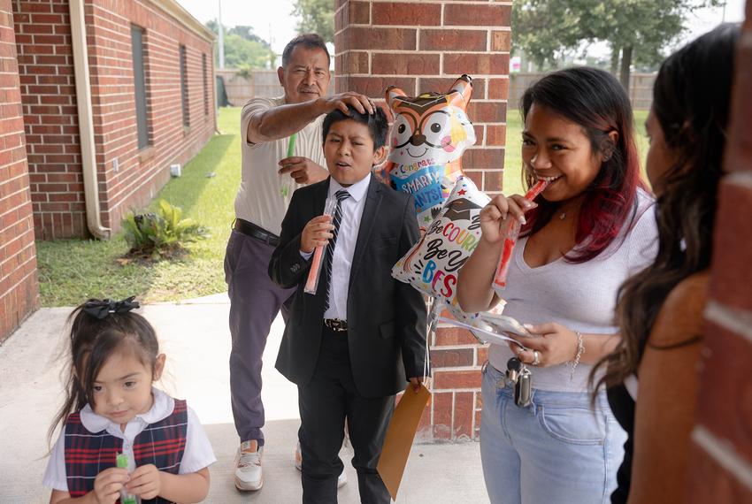 The Avila family hangs outside after Jeremas’ 5th grade graduation ceremony, Tuesday, May 20, 2025, in Houston. 

(Lexi Parra for The Texas Tribune)