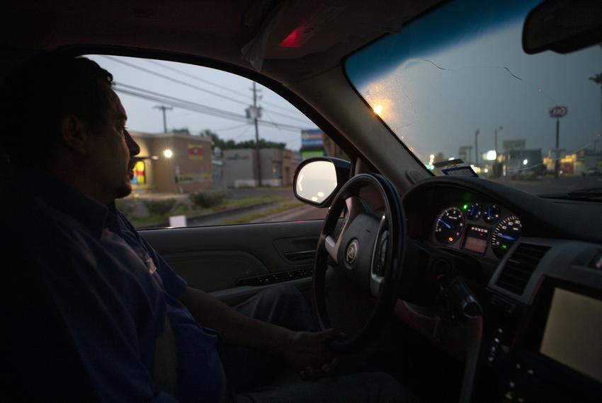 Juan Lopez works in the early morning of the day to pick-up and transport bodies from hospital morgues to funeral homes. S...