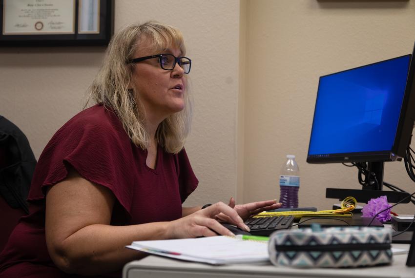 Heather Dulas, the program director of Aggie ACHIEVE, looks at the costs and fees that students can expect to pay within the program, compared to the tuition costs of a degree-seeking Texas A&M University student at the university's campus in College Station on Nov. 15, 2022. Aggie ACHIEVE at Texas A&M University is a comprehensive transition program (CTP) for young adults with intellectual and developmental disabilities (IDD) who have exited high school.