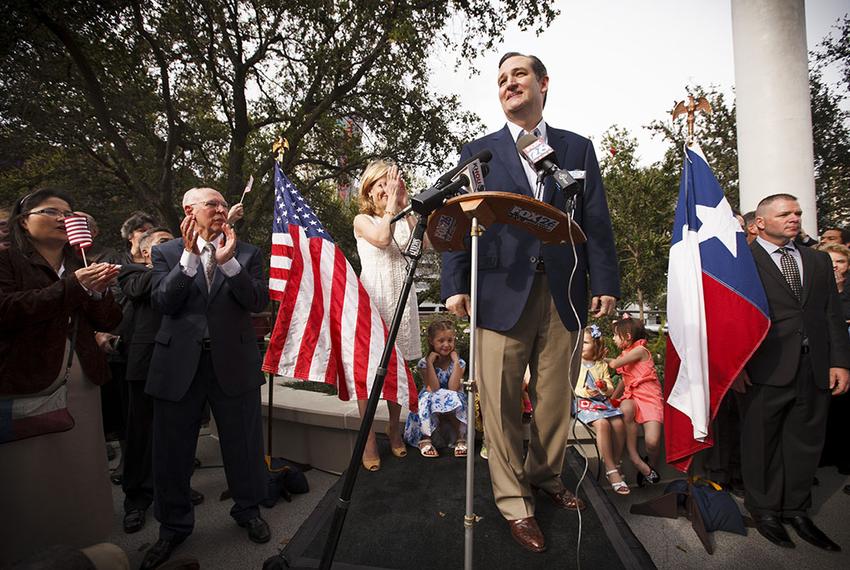 U.S. Sen. Ted Cruz speaks to supporters with his father Rafael, his wife Heidi and their children outside his new presidential campaign headquarters in Houston on March 31, 2015.