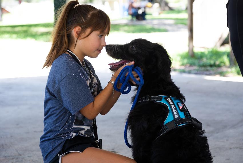 Adrianna Medina, 10, does training with her service dog, Ocean, at Uvalde Memorial Park on Aug. 28, 2022.