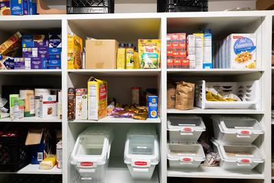 The hospitality coordinator and Perry Covington and his wife Karen keep the pantry stocked witha variety of foods thanks to the food bank and other local charities.