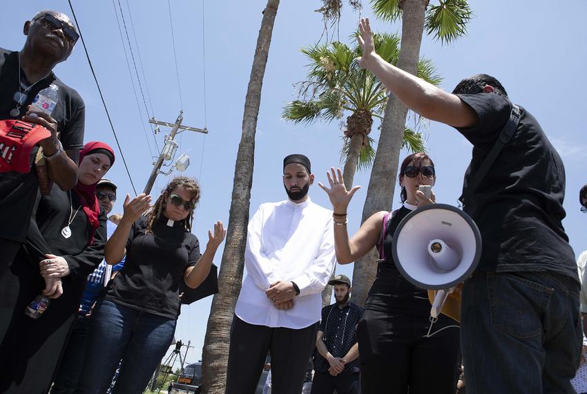 Religious leaders gather for a rally at a McAllen Border Patrol station on June 23, 2018. Protesters blocked a government bus with immigrant children aboard from leaving.