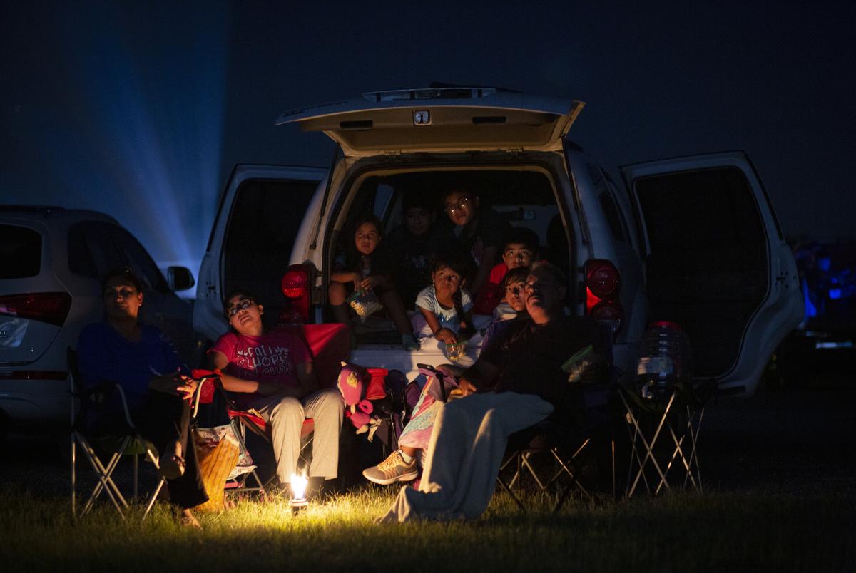 At left, Marta Linares and her family watch a movie at the WesMer Drive-In Theatre in Mercedes. They have been coming to the theatre once a month for the past 15 years.