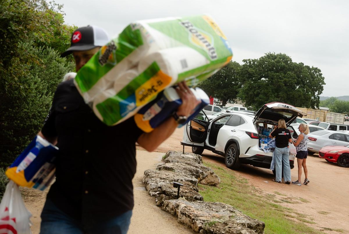 Community members sort donations to help victims of the flood at the Cross Kingdom Church in Kerrville during the first Sunday service after the floods on July 6, 2025.